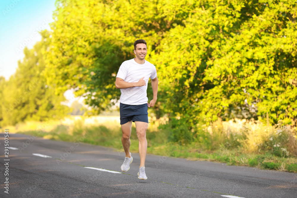 Sporty young man running outdoors Sporty young man running outdoors