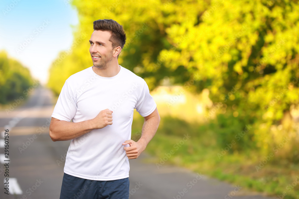 Sporty young man running outdoors