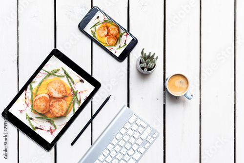 food blog background Desk for food blogger with tablet and smart phone with food photographs