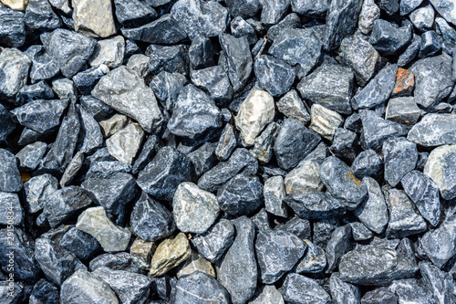 Small rocks or gravel made from stones different shape as stone texture. Used for construction of buildings and roads and as a building material.