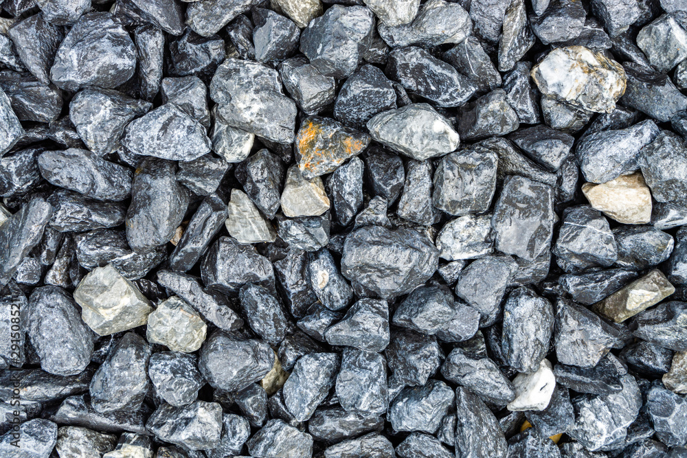 Small rocks or gravel made from stones different shape as stone texture. Used for construction of buildings and roads and as a building material. Small rocks or gravel made from stones different shape as stone texture. Used for construction of buildings and roads and as a building material.