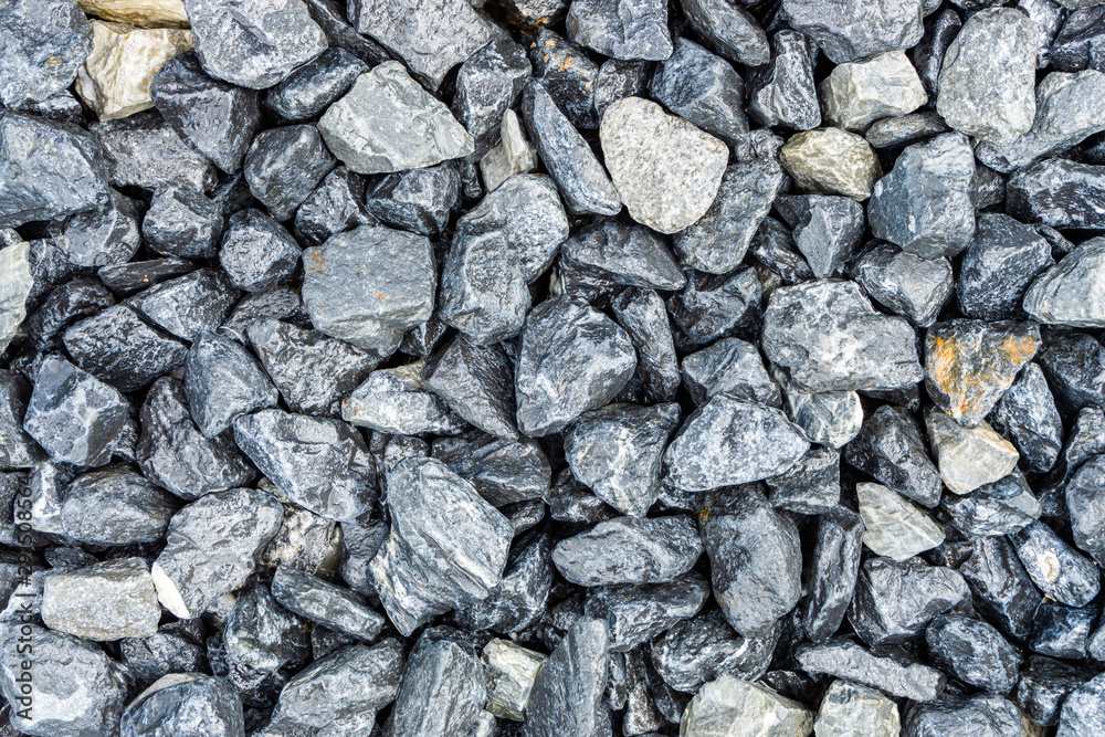 Small rocks or gravel made from stones different shape as stone texture. Used for construction of buildings and roads and as a building material. Small rocks or gravel made from stones different shape as stone texture. Used for construction of buildings and roads and as a building material.