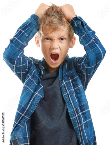 Cuadro en lienzo Portrait of angry little boy on white background