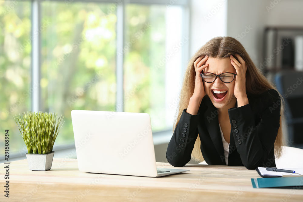 Stressed young woman at workplace Stressed young woman at workplace