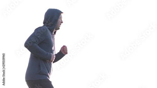 Caucasian mature man running with concentration preparing for marathon. Side view