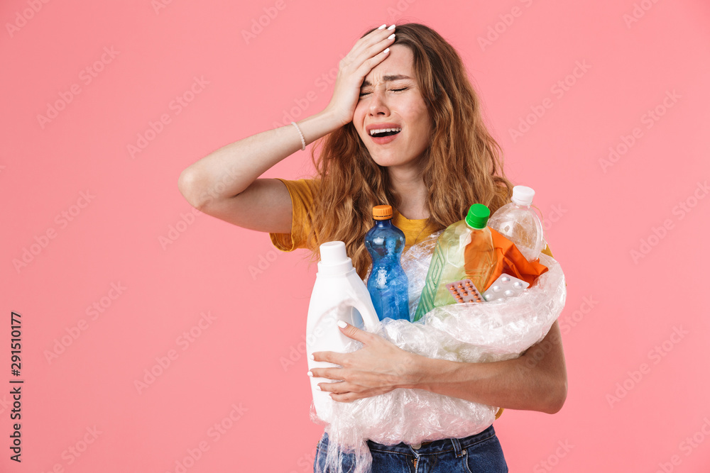 Photo of young unhappy woman holding plastic waste and crying Photo of young unhappy woman holding plastic waste and crying