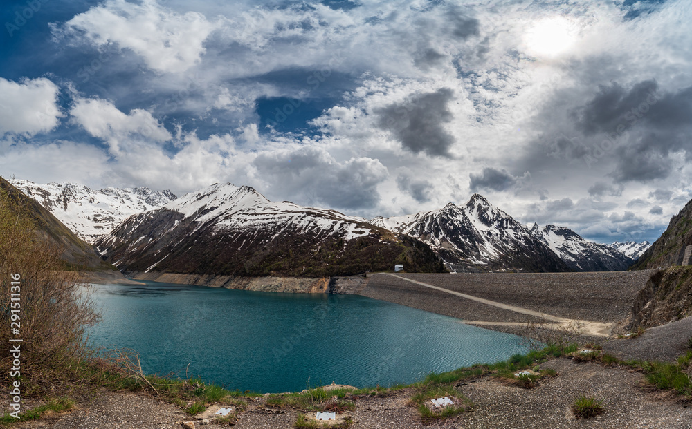 Obraz premium View of Lac de Grand Maison Lake in the French Alps with the Grand'Maison embankment dam on the right. The lake serves as the upper reservoir in a pumped-storage hydroelectric scheme