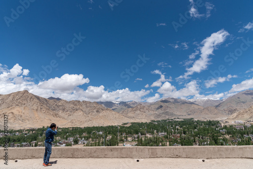 Canvas Print Landscape view of tourist man shooting photo of beautiful of city view in Leh La
