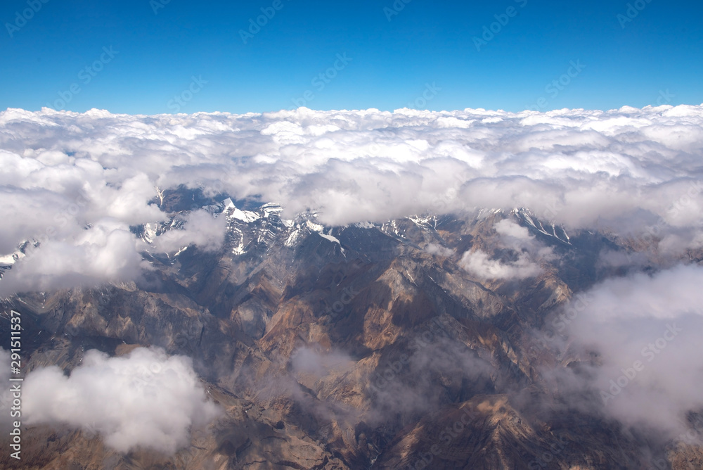 Bird eye view of snow mountains and sky cloud from window of airplane at Leh, India Bird eye view of snow mountains and sky cloud from window of airplane at Leh, India