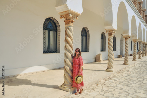 A woman stands next to the twisted spiral columns of a medieval French temple in Carthage, Tunisia. St. Louis Cathedral is a Catholic Church photo