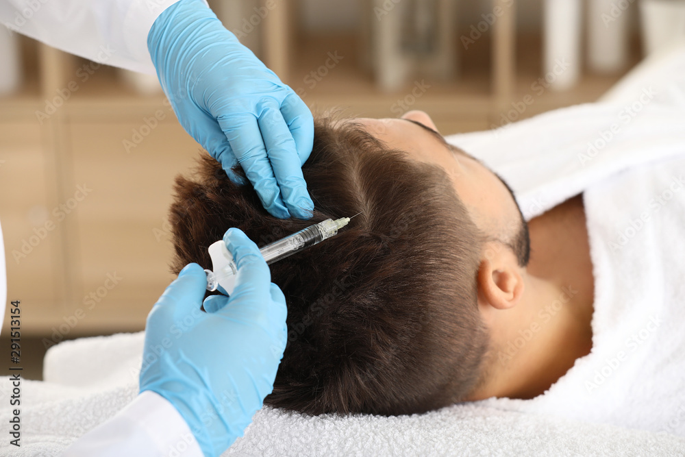 Man with hair loss problem receiving injection in clinic Man with hair loss problem receiving injection in clinic
