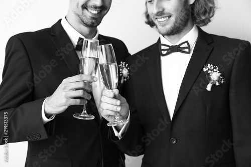 Happy gay couple with champ...