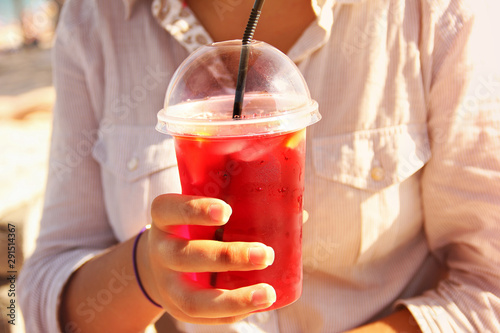 Juicy drink in the hand. Girl drinks a cocktail