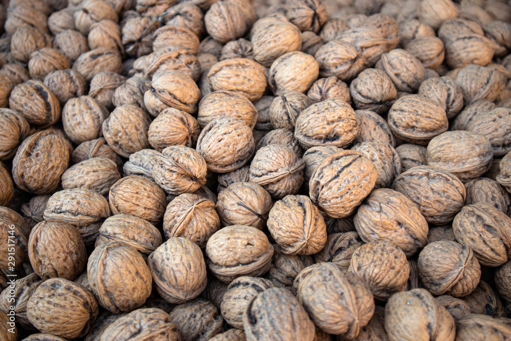 Walnuts with shell background, texture. Closeup view Walnuts with shell background, texture. Closeup view