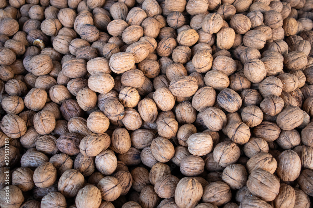 Walnuts with shell background, texture. Top view Walnuts with shell background, texture. Top view