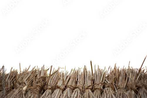 Rice straw arranged in rows on a white background and empty space on top.