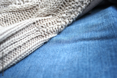Knitted sweater and jeans. Autumn clothes top view. Autumn closet background. 