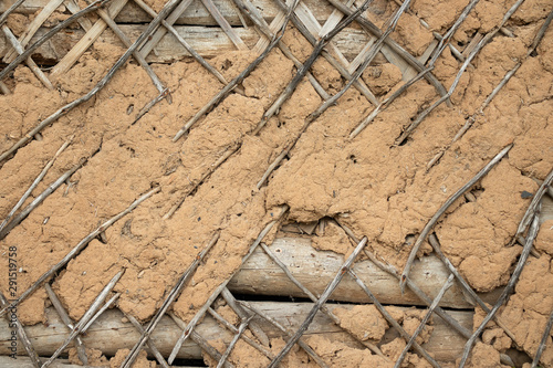The old wall is covered with lath and covered with clay.