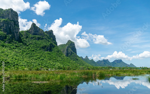 Lotus pond with natural scene and mountains with blue sky at khao sam roi yod national park, thailand