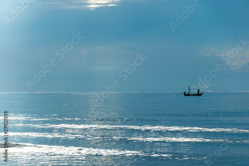Small wood fishing boat on the sea.