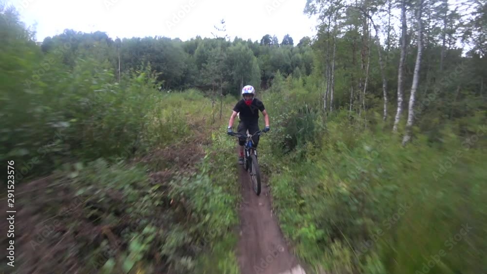 cyclist rides in front of the camera jumps on ski jumps, action camera cyclist rides in front of the camera jumps on ski jumps, action camera