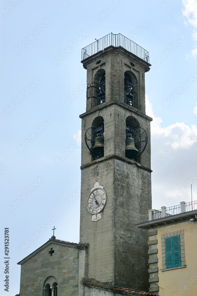 Bell tower of the church of St. Jacopo and Antonio against a blue sky with clouds in Fivizzano, the small Lunigiana town in the province of Massa and Carrara, Tuscany, Italy