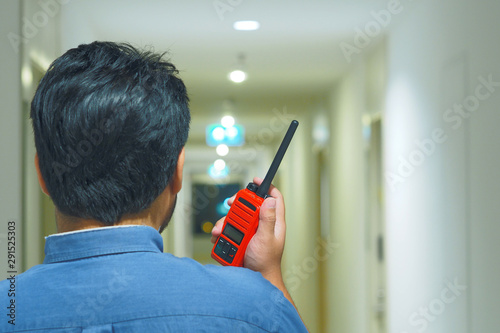 Man with a Walkie Talkie or Portable radio transceiver for Emergency Response Plan