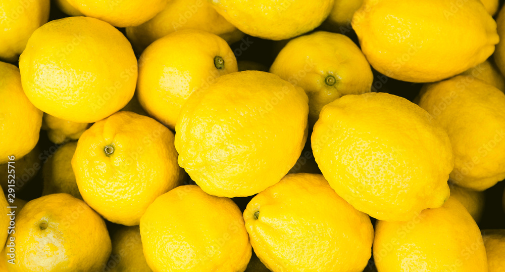 Fresh yellow lemons at the market. Food background Fresh yellow lemons at the market. Food background