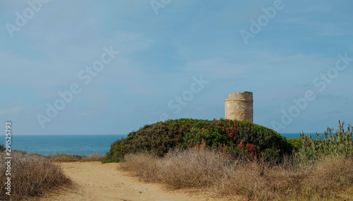 View of the Pig Tower (Torre del Puerco) in Chiclana de la Frontera, Cádiz, Spain.  La Barrosa beach in the background.  photo