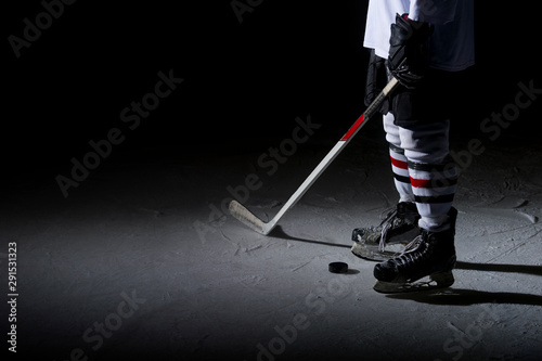 Photography ice hockey player in action kicking with stick