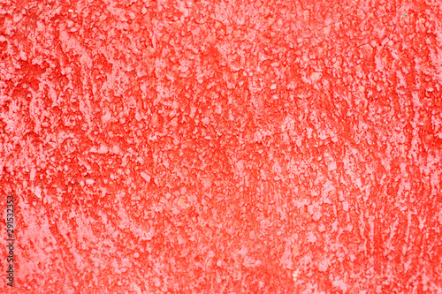 Rough texture of abstract decorative red background of plaster wall.