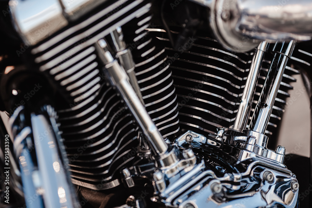 Rivne, Ukraine - September 23, 2019: Harley-Davidson Fat Boy motorcycle detail. Motorcycle engine exhaust pipes. Close up of a classic motorcycle with lots of chrome details. Rivne, Ukraine - September 23, 2019: Harley-Davidson Fat Boy motorcycle detail. Motorcycle engine exhaust pipes. Close up of a classic motorcycle with lots of chrome details.