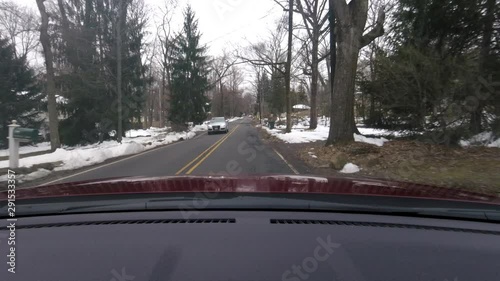 driving suburban area and pulling in driveway red suburban house