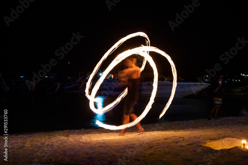 Amazing fire dancers Swing fire dancing show fire show on the beach in Thailand