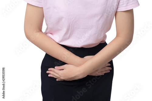 Closeup young sick woman with hands holding pressing her crotch lower abdomen over white background. Medical or gynecologicals or Cystitis problems, healthcare concept