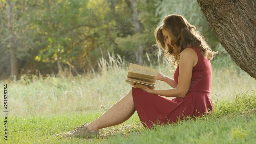 romantic scene beautiful young woman reads a book, profile of cute girl sitting under a tree in the forest, concept hobby and lifestyle romantic scene beautiful young woman reads a book, profile of cute girl sitting under a tree in the forest, concept hobby and lifestyle