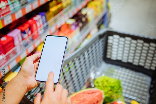phone with empty blank white screen shopping cart on background