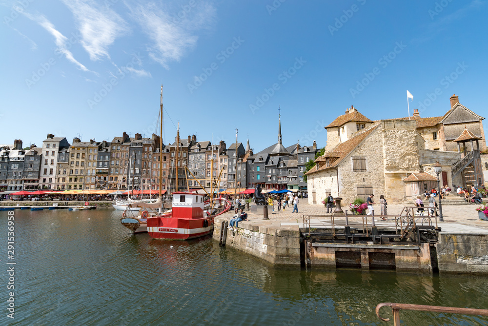people enjoying a beautiful summer day in the village of Honfleur in Normandy