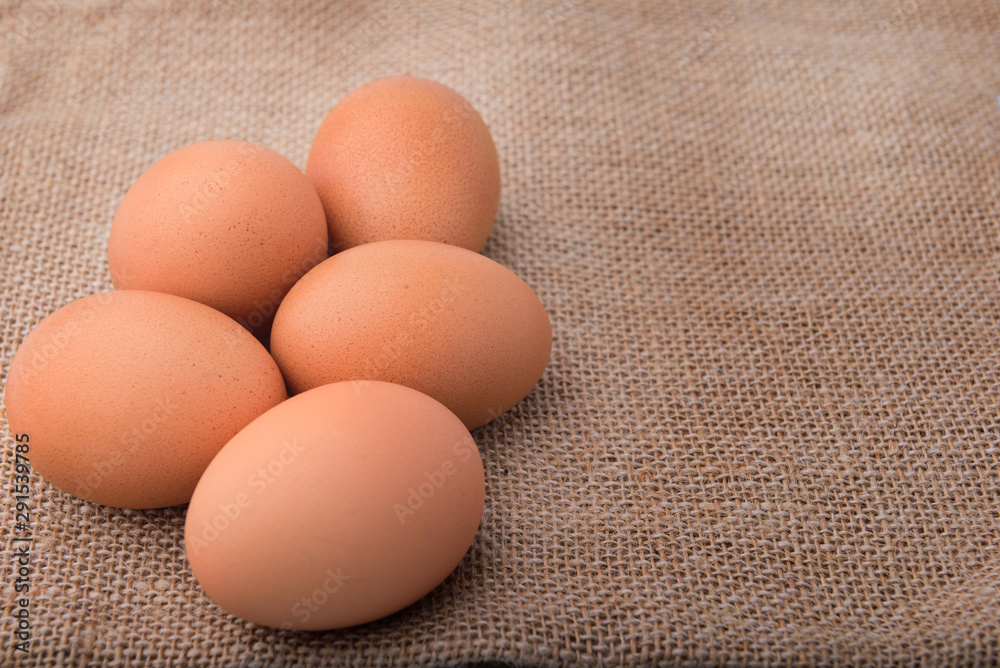 Fresh eggs on sackcloth. Copy the area for the text on the background, sackcloth, brown. Fresh eggs on sackcloth. Copy the area for the text on the background, sackcloth, brown.