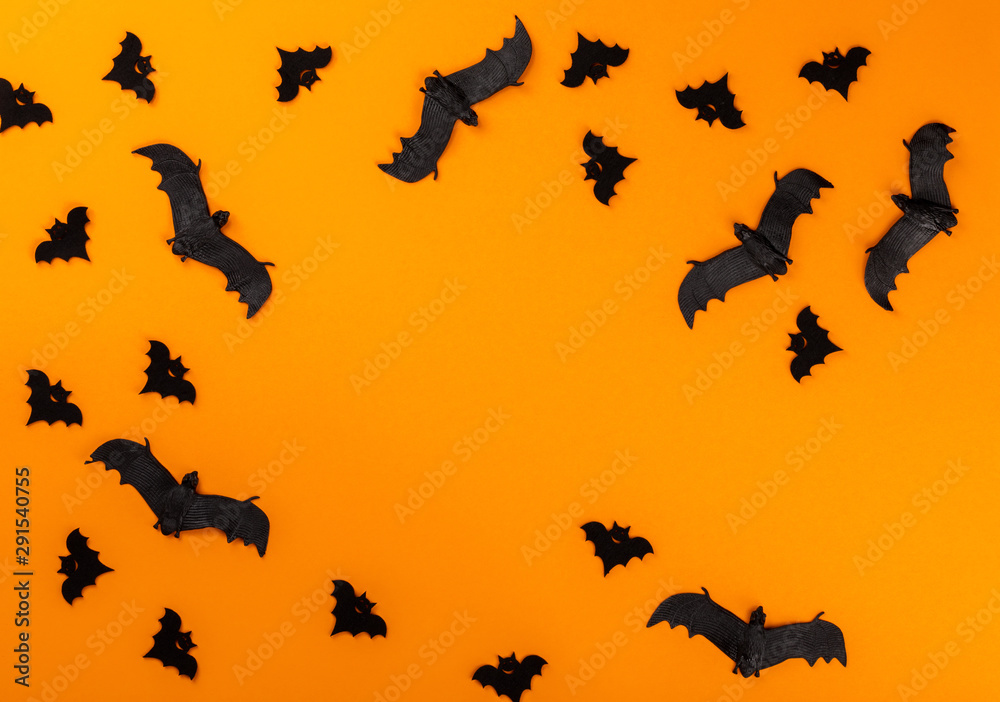 Fototapeta premium Halloween postcard. Тraditional festival of autumn. Decoration and party concept .Bats on a orange background .Flat lay, top view, copy space