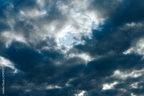 a lot of dark clouds at blue sky background