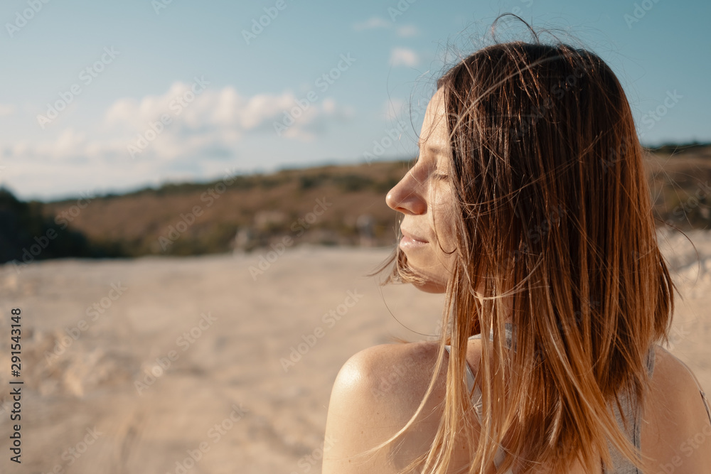 Young girl walks in a career sunny summer evening Young girl walks in a career sunny summer evening