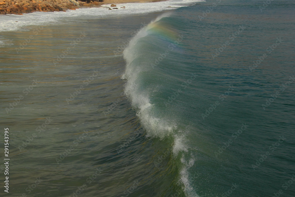 Malibu waves high tide with rainbow reflection