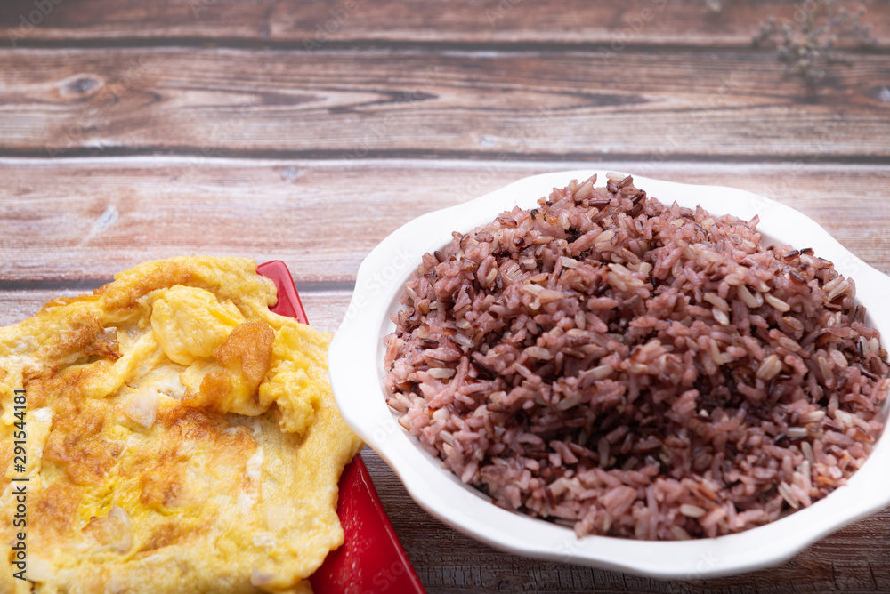 Riceberry 1 bowl of white and omelette in a red dish On the old wooden floor, copy the area for the text Riceberry 1 bowl of white and omelette in a red dish On the old wooden floor, copy the area for the text