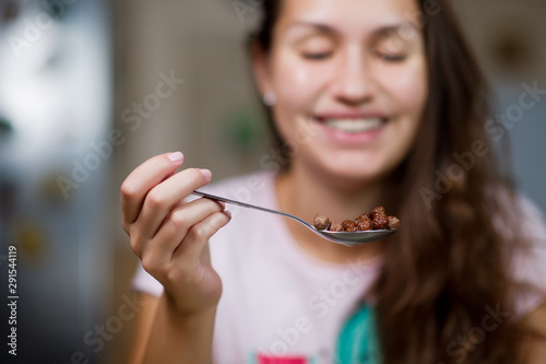 a chocolate cereal and a girl smile in the background