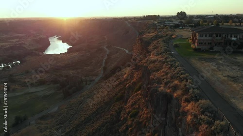 Aerial footage of Snake River Canyon in Twin Falls, Idaho, USA. In the center background can be seen the I.B Perrine Bridge, a four lane truss arch bridge, on which the U.S Highway 93 runs photo