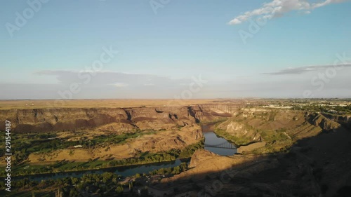 Aerial footage of Snake River Canyon in Twin Falls, Idaho, USA. In the center background can be seen the I.B Perrine Bridge, a four lane truss arch bridge, on which the U.S Highway 93 runs photo