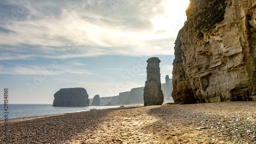 Marsden Beach/Bay located in South Shields near Sunderland. Beach is located next to a limestone rock cliff face (the Leas), showing sandy beach, rocks, sea and eroded cliffs.