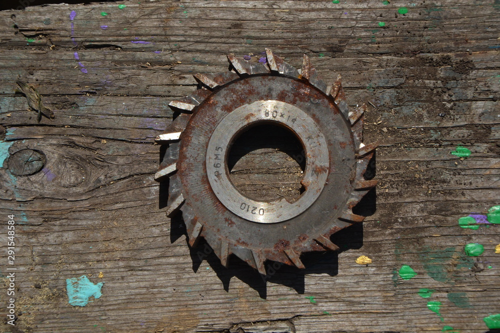 Fototapeta premium old used gears on a wooden background