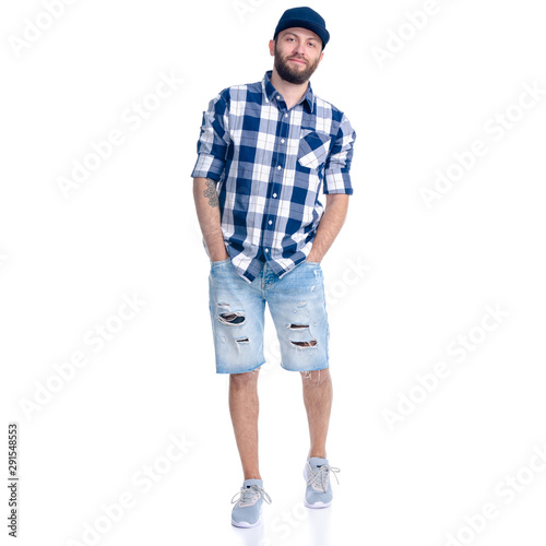 Man in jeans shorts, cap, casual clothing standing smiling on white background isolation